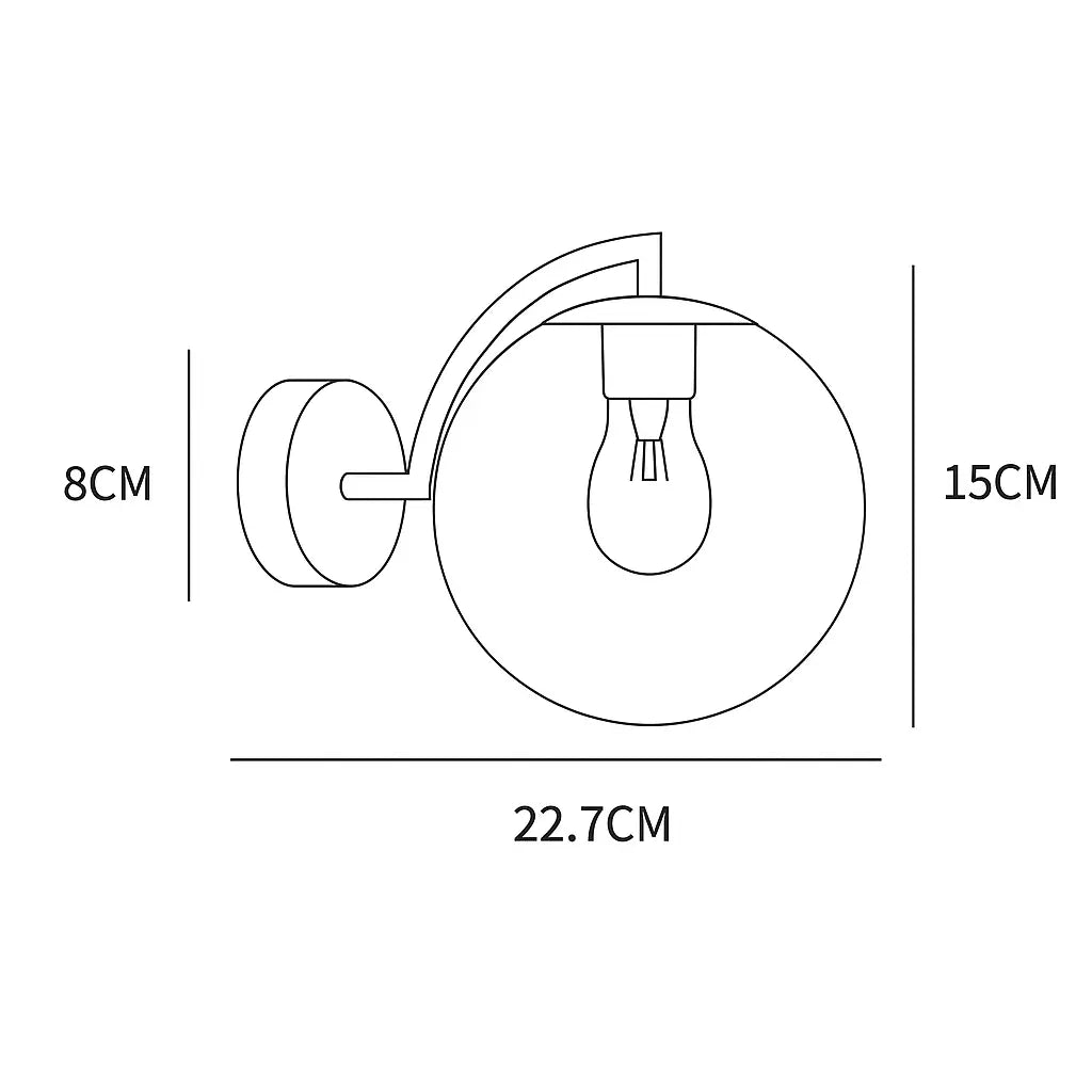Elegant curved brass wall light, glass globe radiates soft, stylish illumination; vintage appeal.