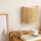 The natural rattan wood wall light casts a soft, warm glow for cozy ambiance.