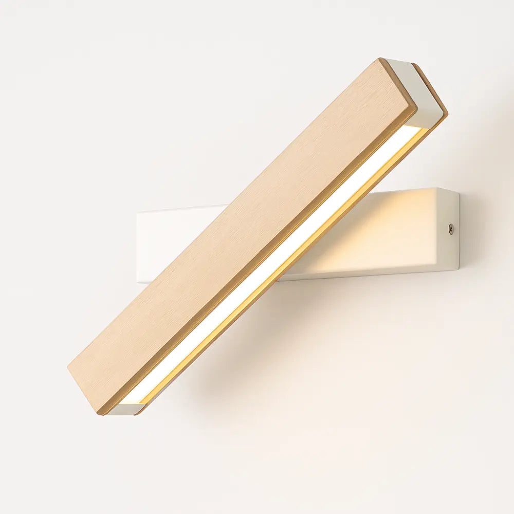 Minimalist LED wall light emits a soft, warm glow from its rectangular wooden shade.