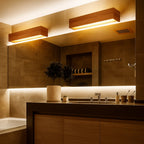 Warm LED lighting from an ORLUNE HOME wall light creates a welcoming bathroom glow.