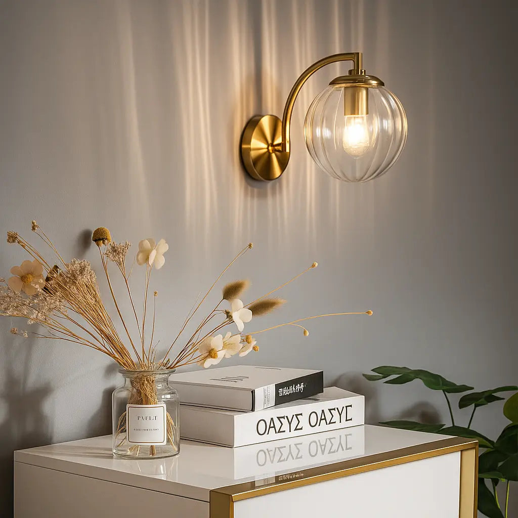This retro brass wall light with glass globe emits a warm, welcoming ambient glow.