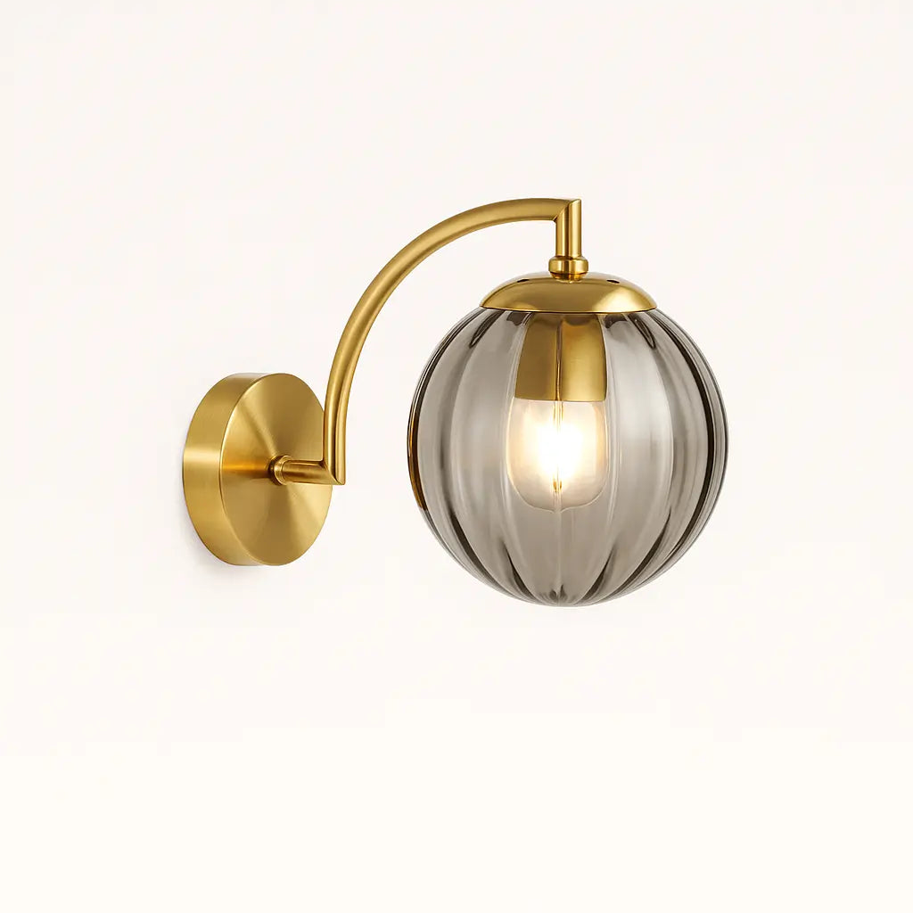 Illuminate your space with this modern ribbed glass wall light and warm brass glow.