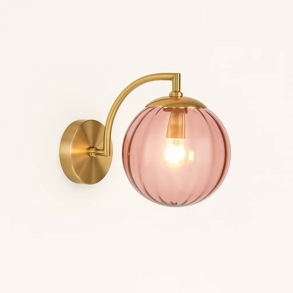 Brighten your room with chic brass and a glowing pink ribbed glass globe shade.