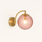 Brighten your room with chic brass and a glowing pink ribbed glass globe shade.