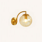 Elegant retro brass wall light with ribbed glass globe creates a warm, inviting glow.