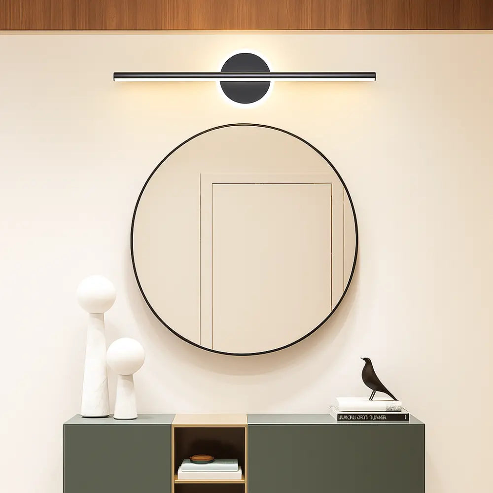 Luminaire LED linéaire métal avec design de cercles noir et or au-dessus d'un miroir.