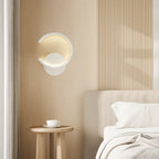 Carved Metal LED Wall Light Directional glowing on vertically grooved light wood-paneled wall.