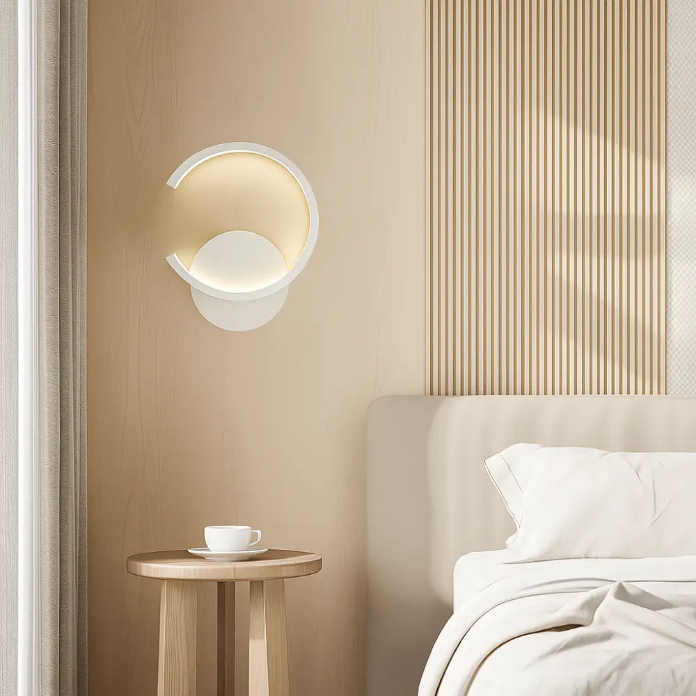 Carved Metal LED Wall Light Directional glowing on vertically grooved light wood-paneled wall.