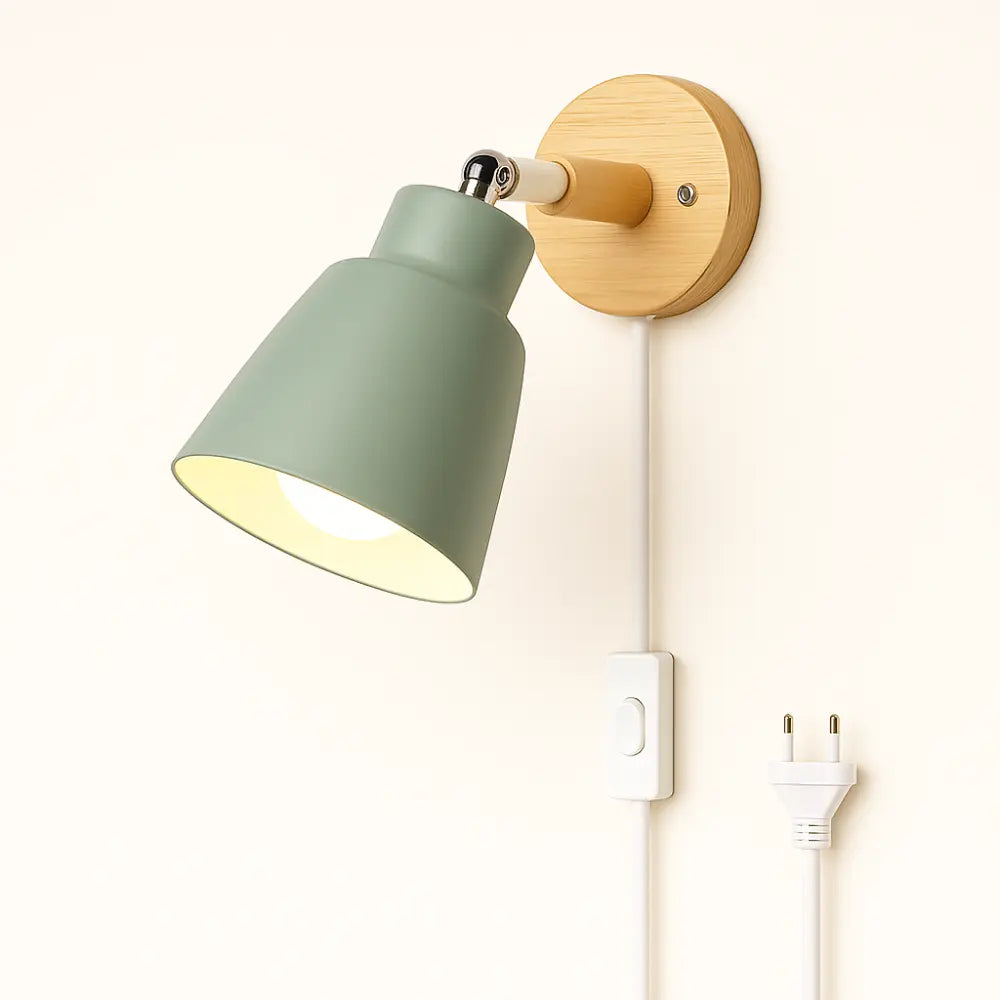 Softly glowing, the green-shaded wall light casts a warm, inviting Nordic ambiance.