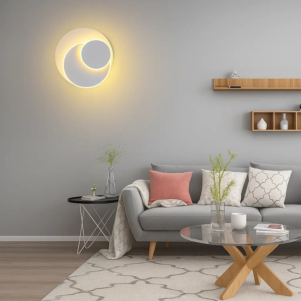 A Modern Adjustable Round LED Metal Wall Sconce glowing softly on a gray wall.
