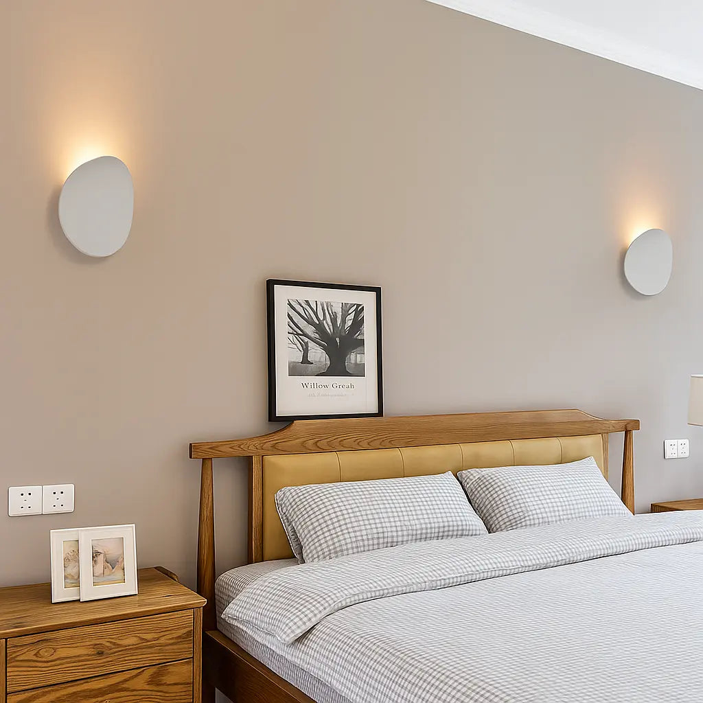 Two sleek white aluminum LED wall sconces create modern, balanced bedroom illumination.