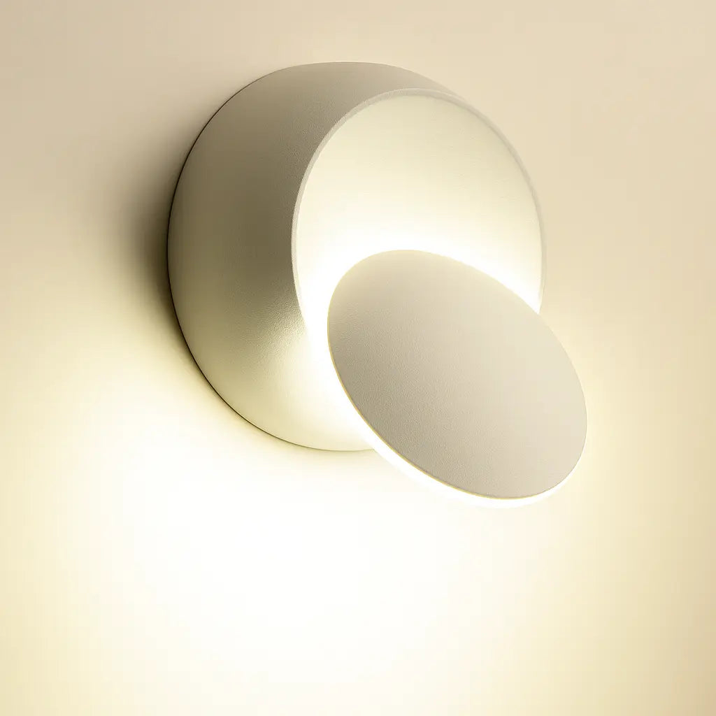 Soft, warm LED radiance with overlapping discs creates gentle, artistic light and unique wall shadows.