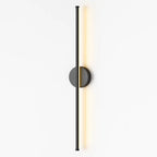Warm LED light glows softly from a sleek black matte wall fixture, illuminating the space.