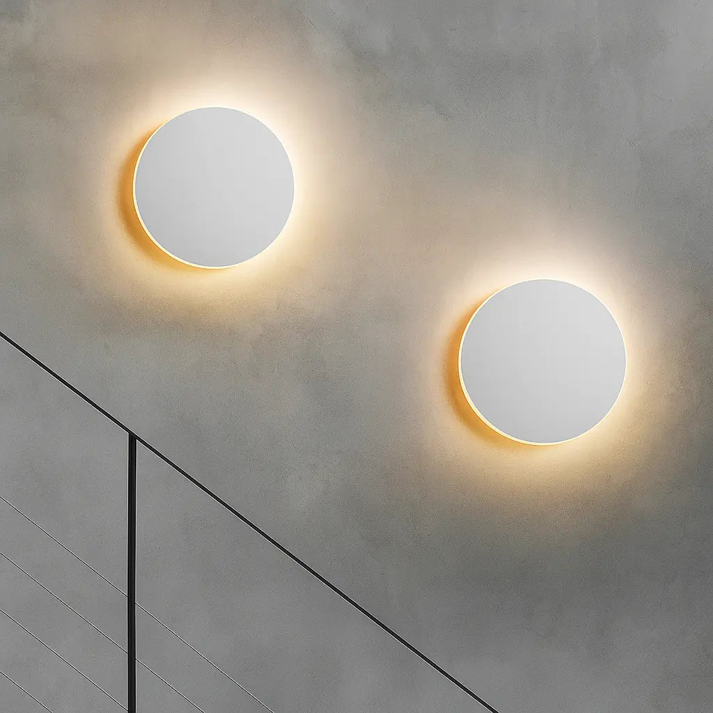 Minimalist black LED wall lights emit a cozy yellow glow, enhancing modern ambience.