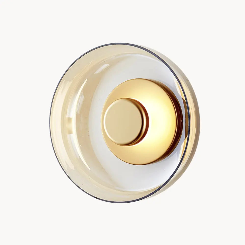 Round LED wall light with gold metallic center and tinted glass ring, glass and aluminum.