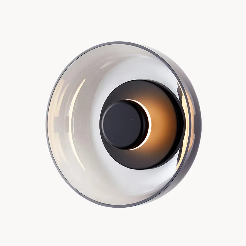 Experience gentle, warm illumination with a glossy, circular LED glass wall light.
