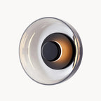 Experience gentle, warm illumination with a glossy, circular LED glass wall light.