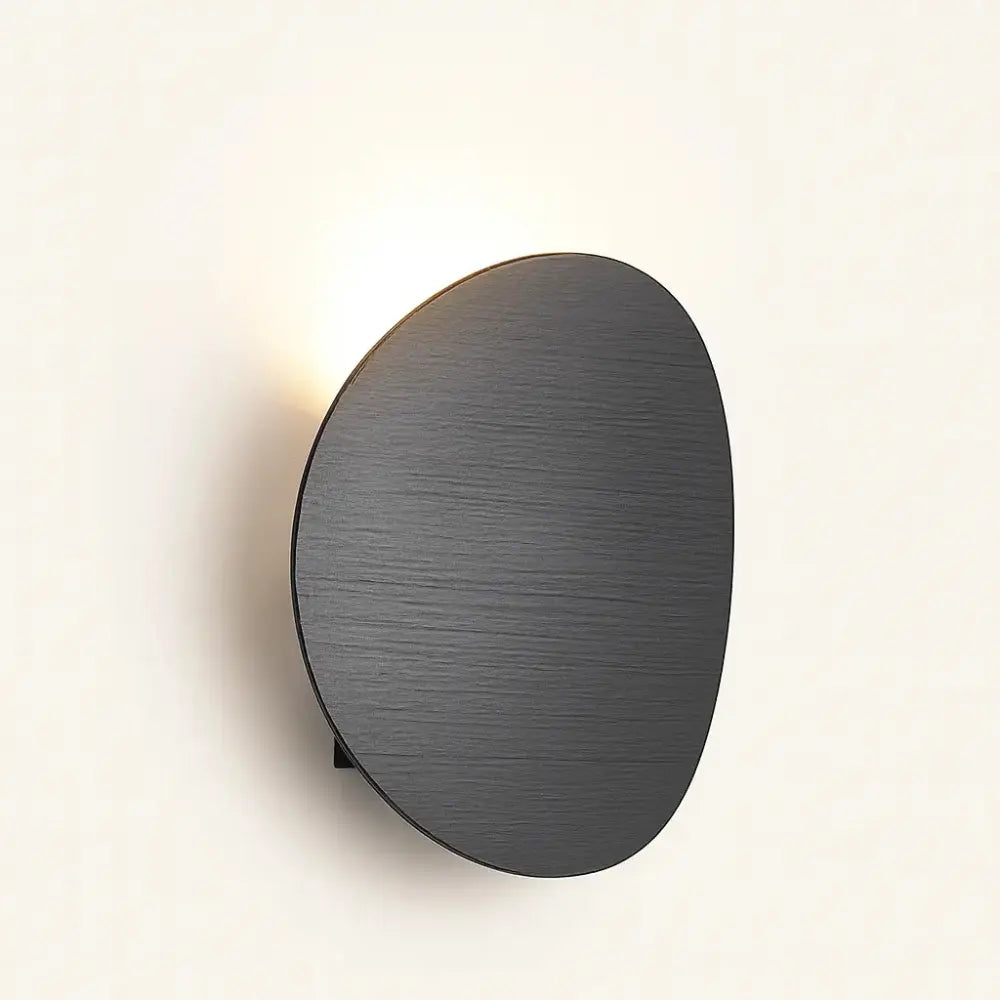 Enjoy soft, modern lighting with this sleek round LED wall sconce for any space.