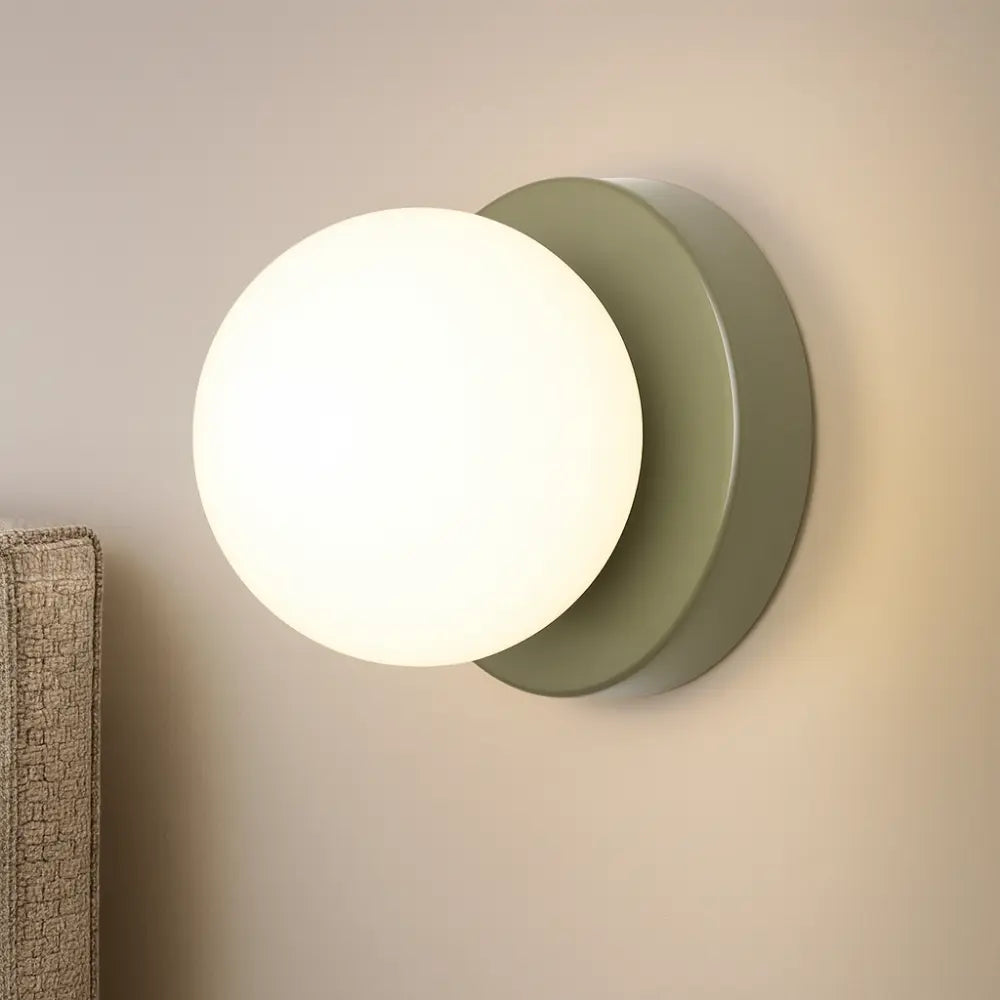 Soft, round opal glass glows warmly on a matte gray base, creating ambient lighting.