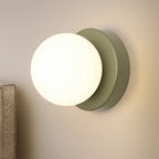 Soft, round opal glass glows warmly on a matte gray base, creating ambient lighting.
