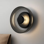 Soft LED light glows from a black aluminum base and glass diffuser for cozy ambiance.