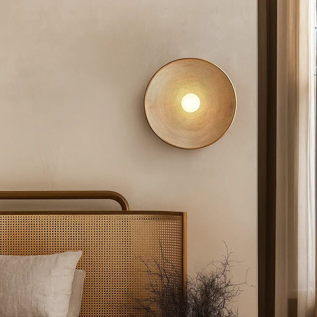 A wavy resin LED wall light in Wabi-Sabi style glows warmly against a beige wall.