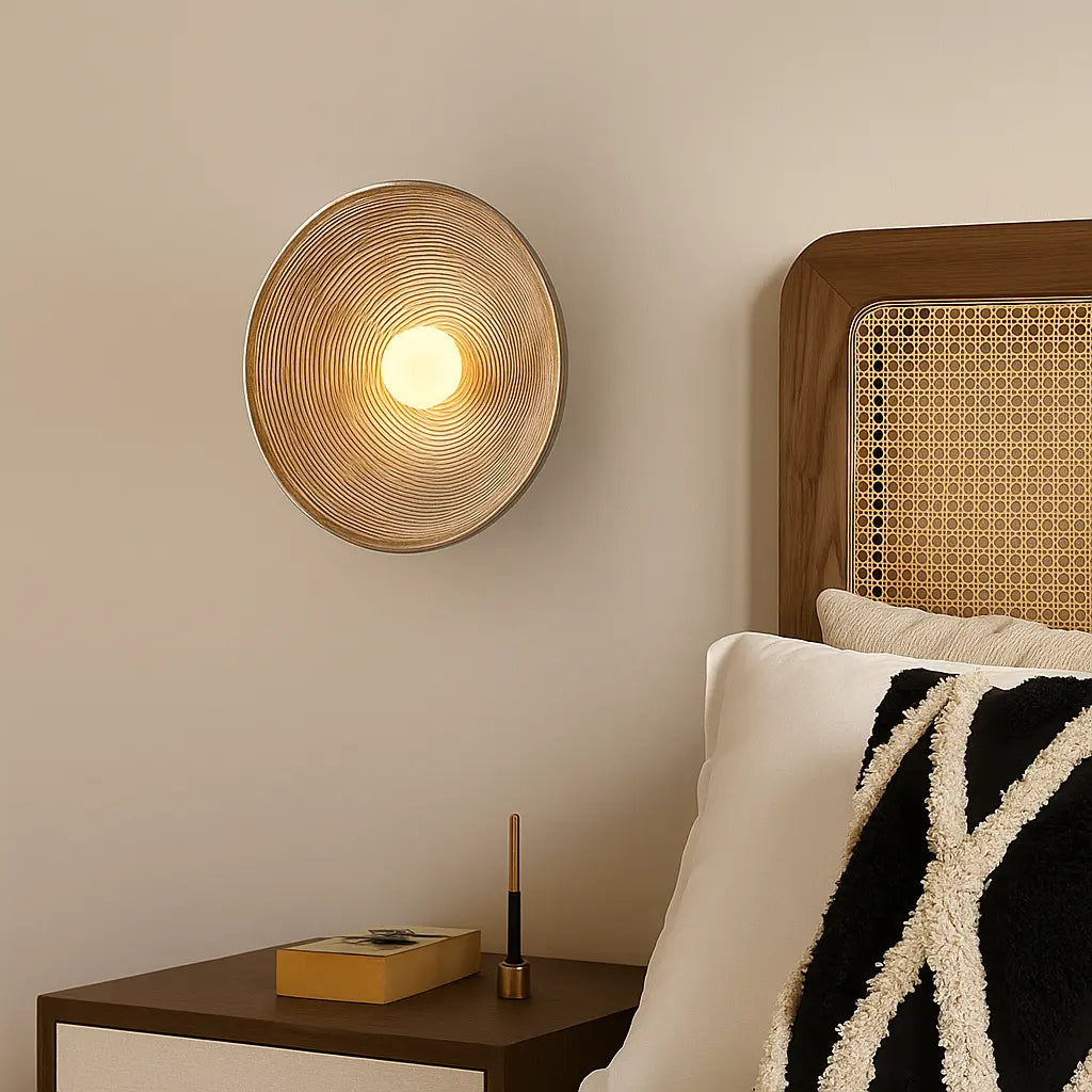 The Wavy Resin LED Wall Light in Wabi-Sabi style has a round, textured, glowing design.