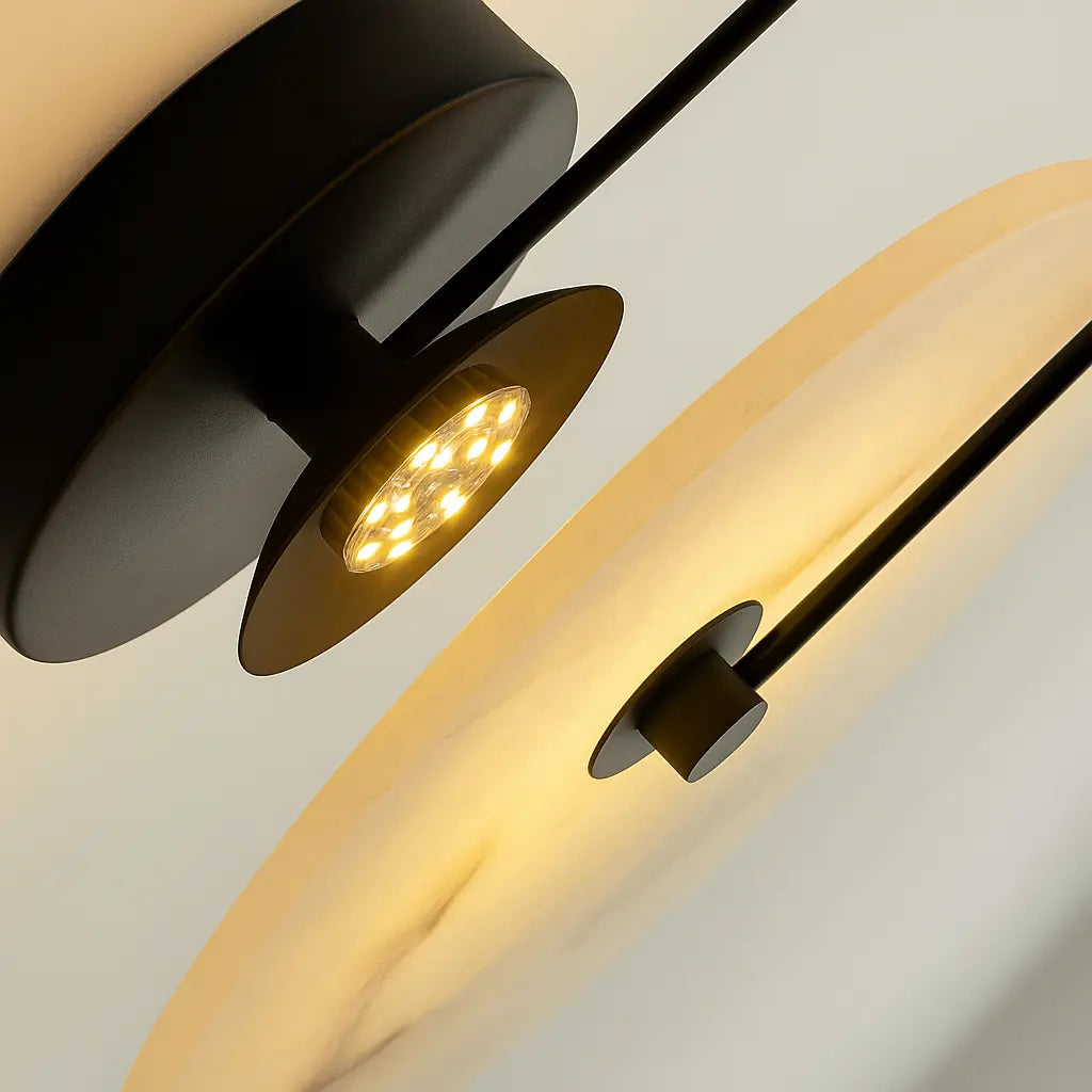 Circular LED wall lamp with translucent shade on black rods, emitting a warm, soft glow.