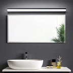 A Contemporary LED Bathroom Wall Light with an acrylic lampshade, mounted above a mirror.