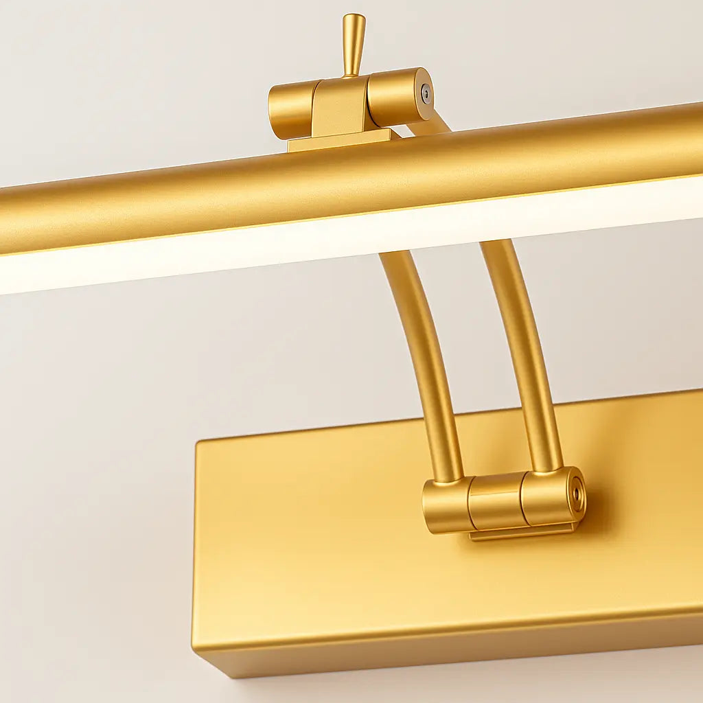Close-up of modern gold wall sconce with cylindrical arm and rectangular base, LED integrated.