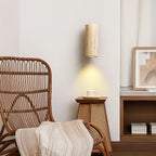 Warm, circular LED wall light brightens art, creating a tranquil, softly illuminated atmosphere.