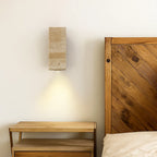 ORLUNE HOME's round LED wall light bathes white walls in a warm, gentle glow.