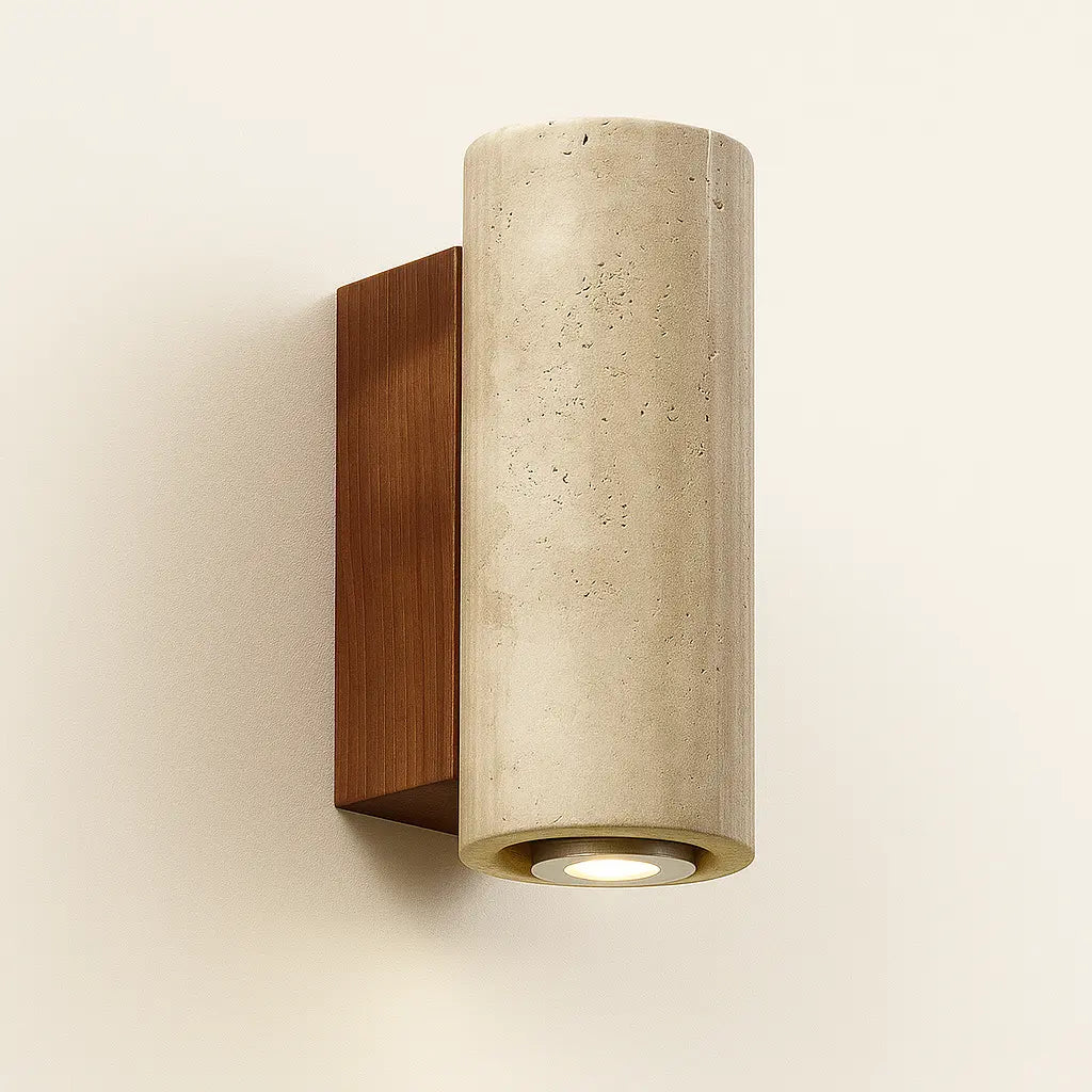 This wall light emits a gentle, warm downward glow with minimalist travertine style.