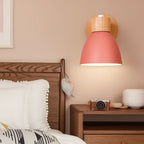 Soft Nordic wall light with a pink shade adds cozy, modern illumination to the room.