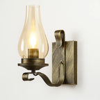 Illuminate with vintage charm: antique brass, candle-style bulb, clear chimney for warm glow.