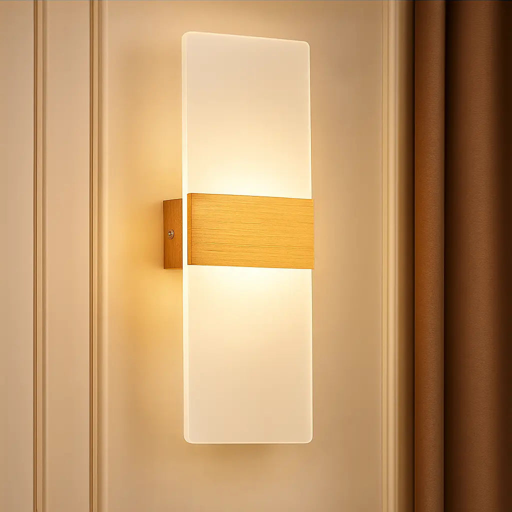 Rectangular LED wall sconce with brushed metal and frosted acrylic shade, emits warm light.