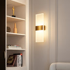 Rectangular brushed metal acrylic LED wall sconce with frosted glass shade, illuminated.