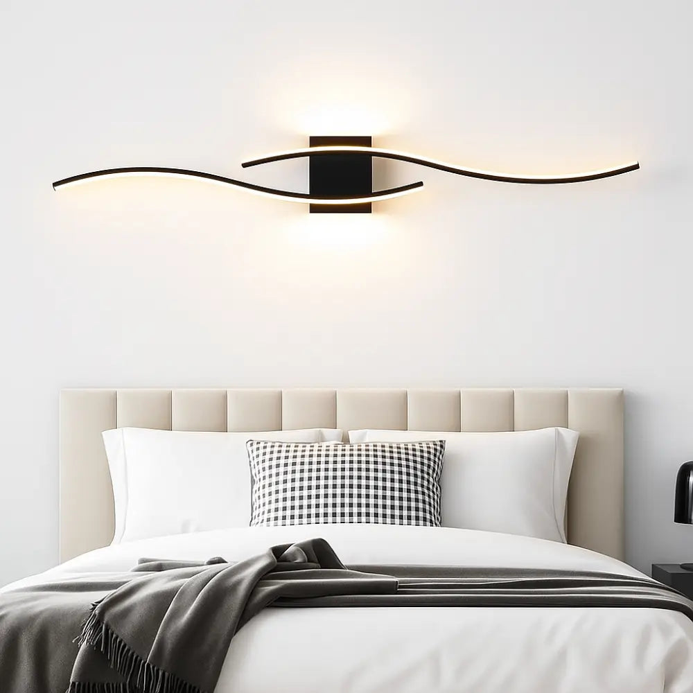 The modern LED wave wall light adds a striking, elegant glow above the bed.