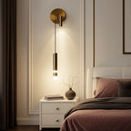 Adjustable LED cylindrical wall light in aluminum acrylic, casting warm illumination on the paneled wall.