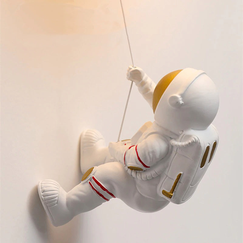 A playful planet-shaped glass wall light with bright accents, designed for a child's room.