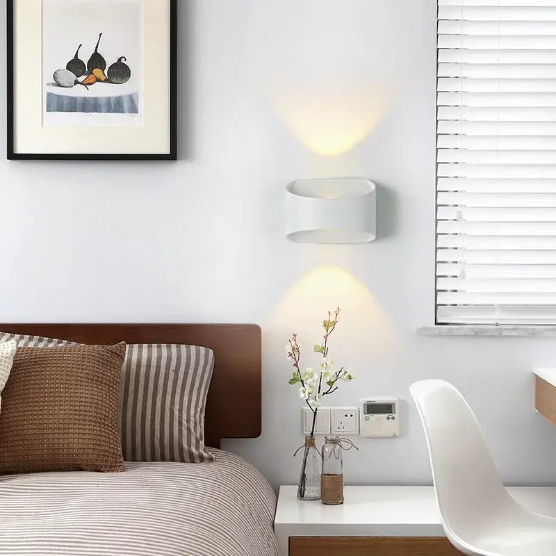 A rectangular aluminum outdoor wall light, IP65 rated, with LED illumination, mounted on the wall.