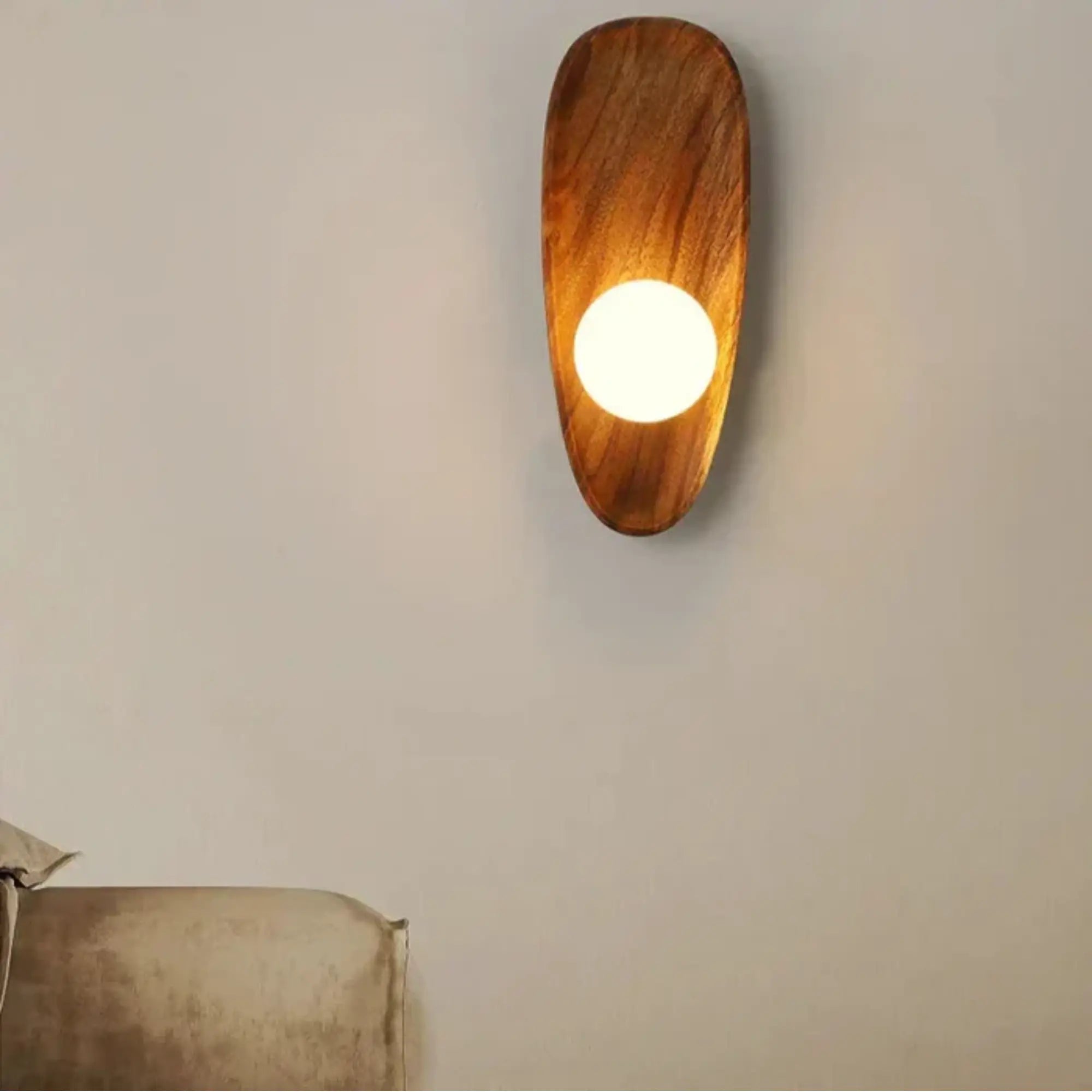 A round natural wood LED wall light with a glowing opal diffuser, modern and sleek.