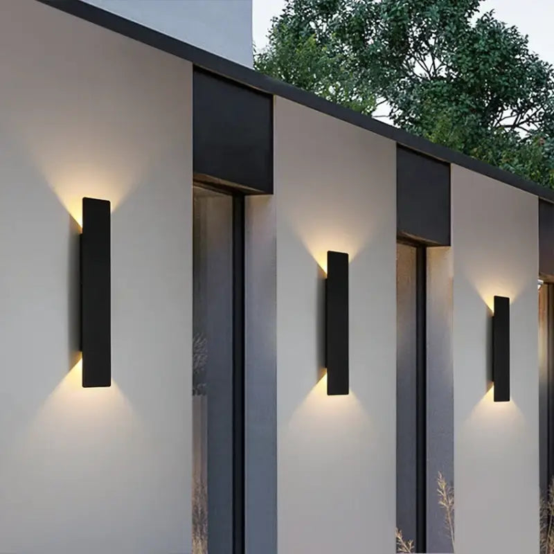 Aluminum outdoor wall light with modern, minimal design, casting up and down illumination.