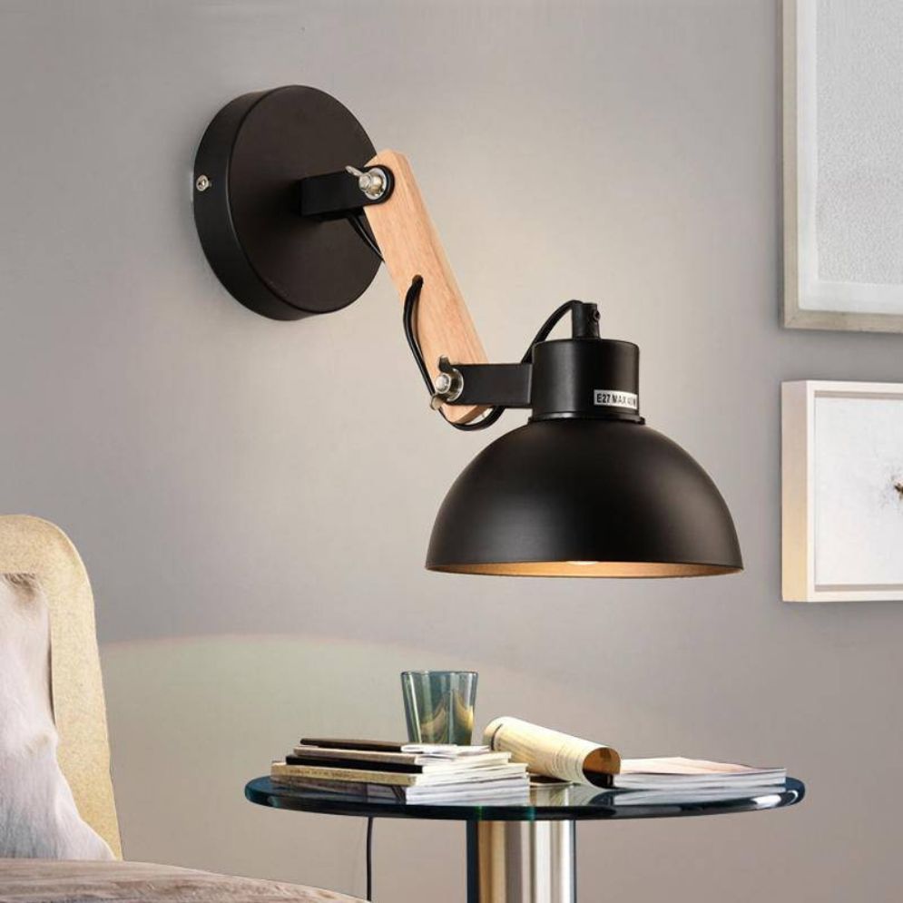 An adjustable LED-compatible wall light with a wooden metal shade mounted on a gray wall.