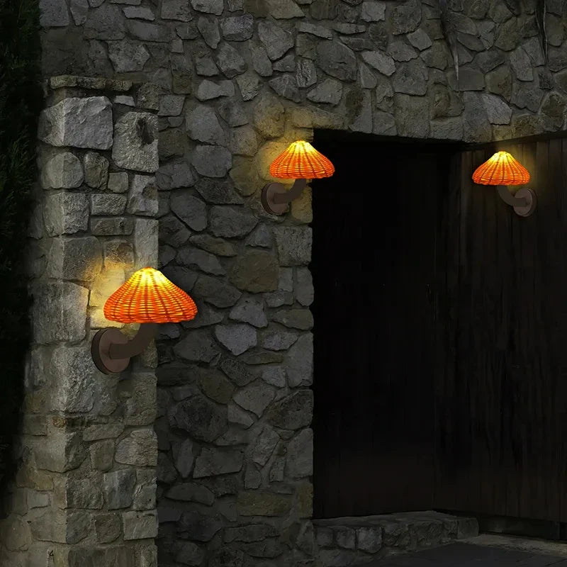 Warm rattan wall lights create inviting illumination, highlighting the unique stone texture at night.