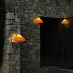 Warm rattan wall lights create inviting illumination, highlighting the unique stone texture at night.