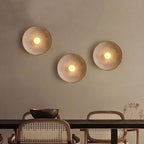 Three Nordic round LED wall lights emit a warm, inviting bathroom glow above.