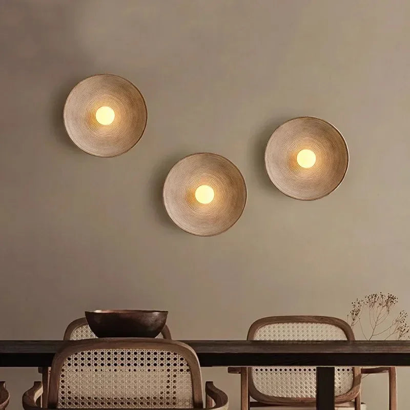 Three Nordic Round LED Resin Wall Lights by ORLUNE HOME cast a warm, woven glow.