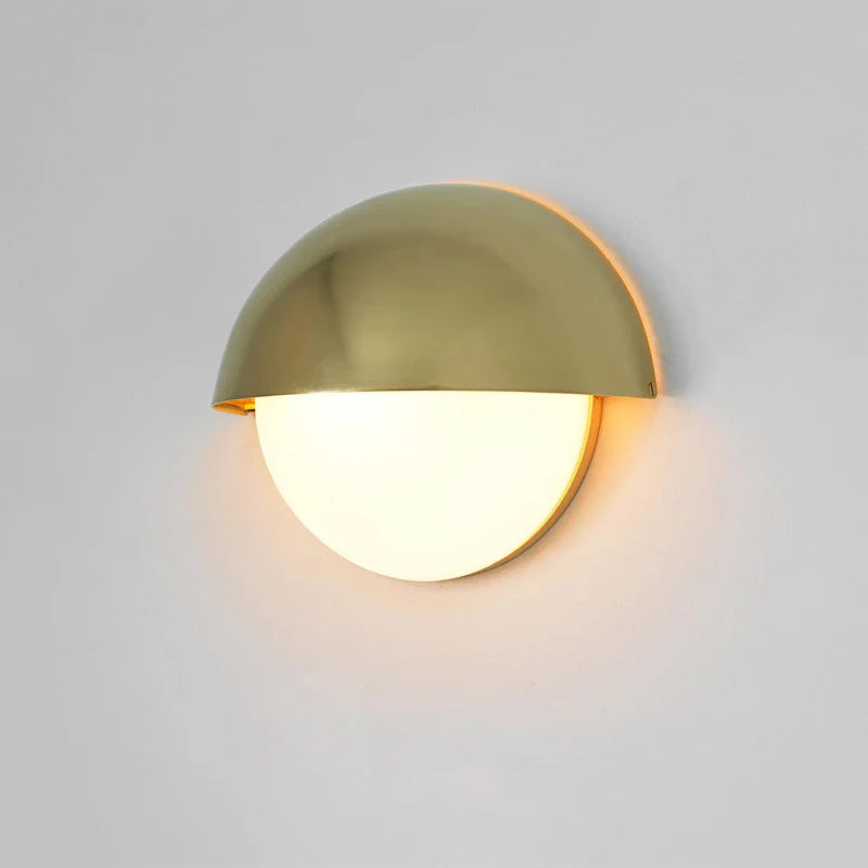 This half-moon LED wall light casts warm, elegant illumination with its brass and gold design.