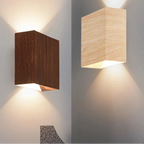 Warm LED beams glow upward and downward in chic contrast from dark and light wooden wall lights.